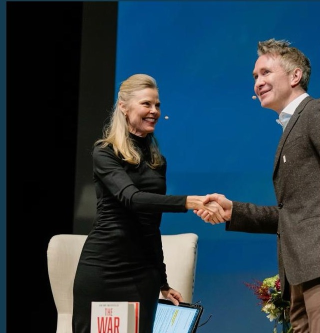 Speakers on stage at the Sun Valley Policy Forum shaking hands after a discussion